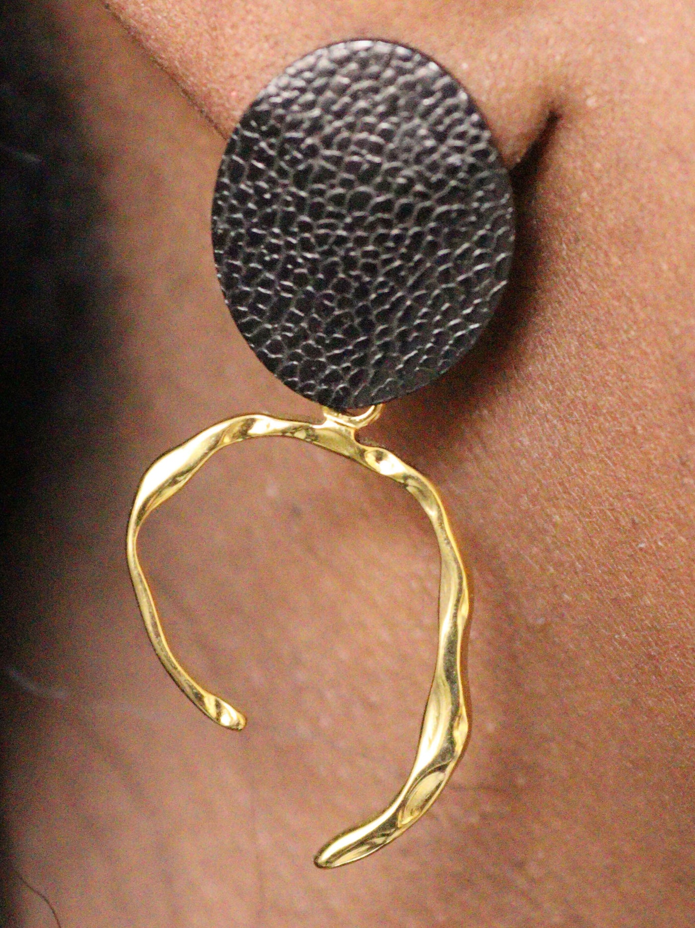 a woman wearing non tarnish, budget friendly 18k gold plated arc earrings