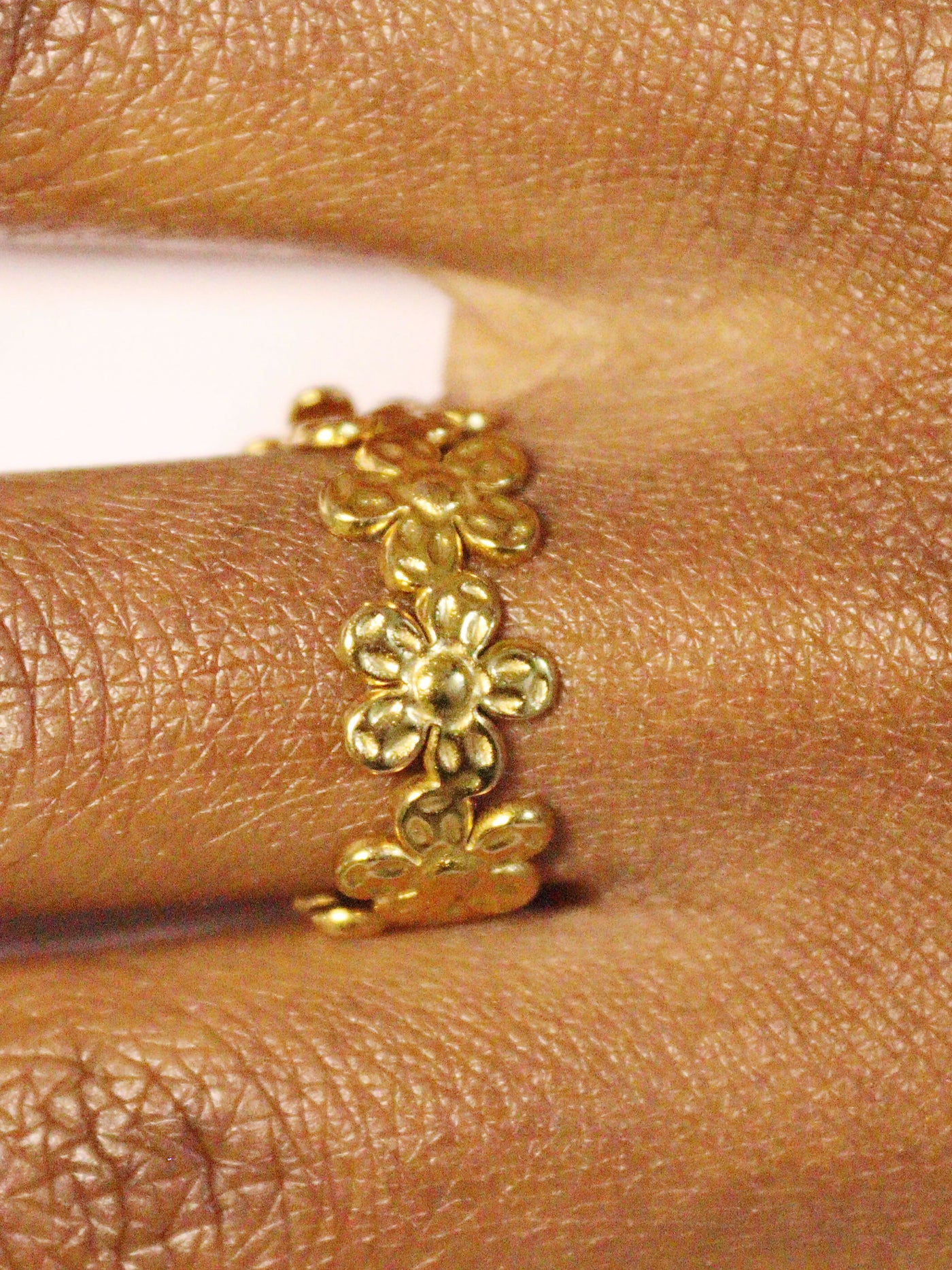a woman wearing non tarnish, budget friendly 18k gold plated floral wrap ring