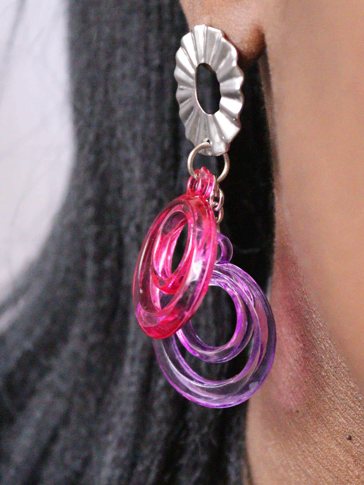 a woman wearing non tarnish, budget friendly fuschia purple double o earrings